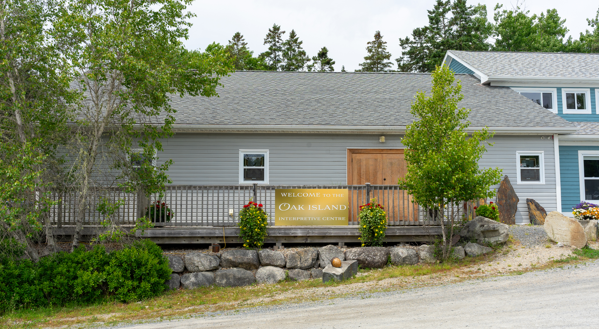 Exterior of the Oak Island Interpretive Centre with visitors arriving for a tour