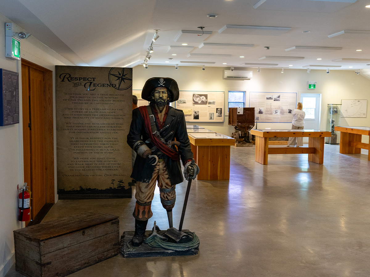 A life-size pirate statue and the “Respect the Legend” narrative panel greeting visitors in the main hall of the Interpretive Centre