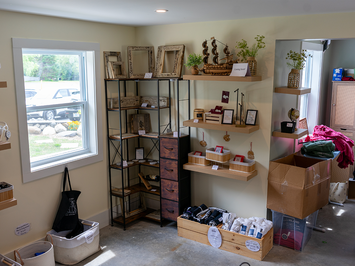 A corner of the Treasure Shop with carved-wood Oak Island picture frames and a display tall-ship model